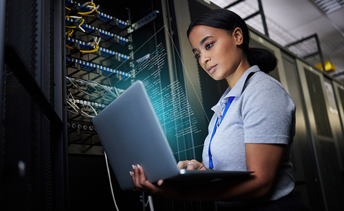 Woman working on laptop in backend office