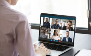 Someone watching a webinar on a laptop