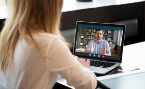 Woman watching webinar on a laptop